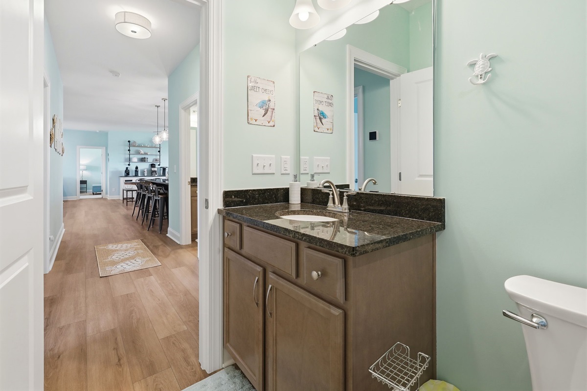 Easy access bathroom with clean vanity and hallway connection