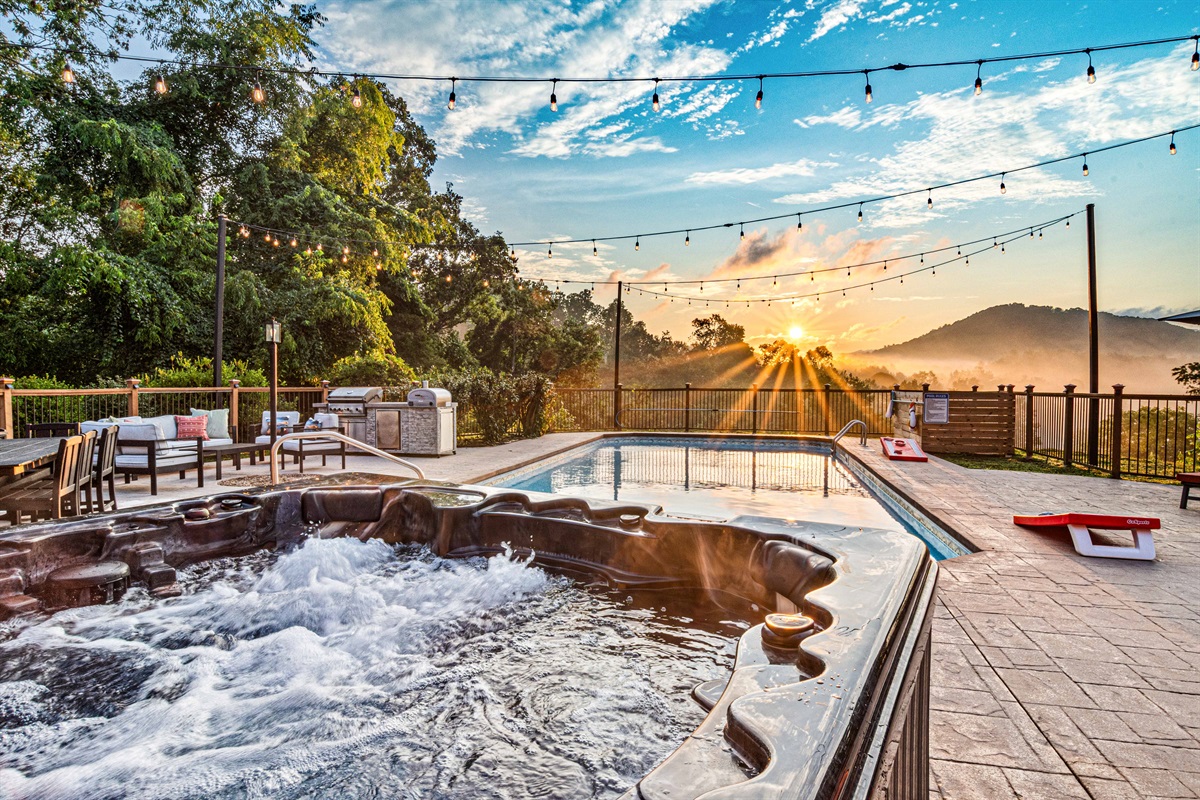 Your own private resort experience, complete with glowing string lights, lounge seating, and a sparkling pool set against the morning sky. The outdoor pool is open May 1 through October 1.