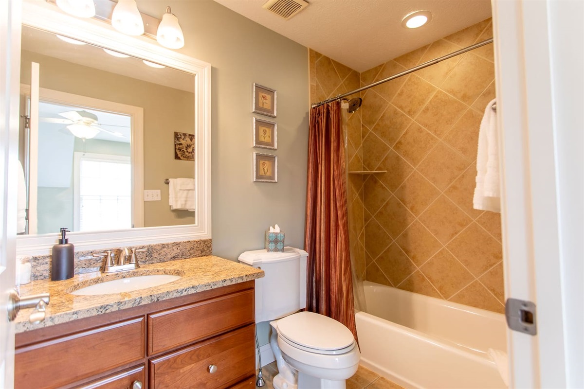 Full bathroom featuring a shower, toilet, sink, and all the essential toiletries, designed for your comfort and convenience.