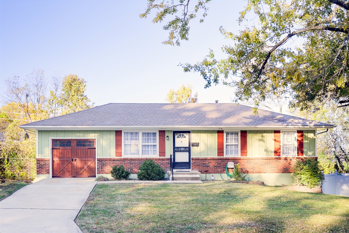 Charming street-front view with mature trees and easy curb access, offering a welcoming first impression.