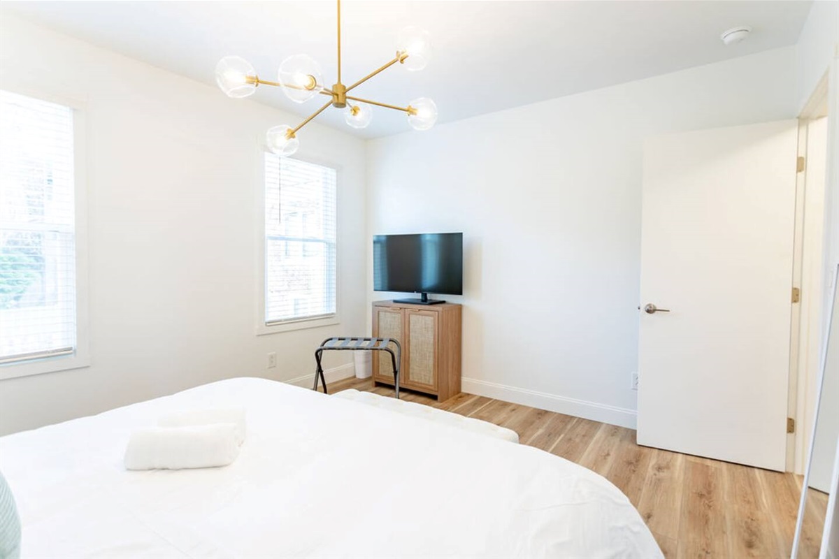 Bedroom view facing a flat-screen TV, creating a cozy and entertaining space.