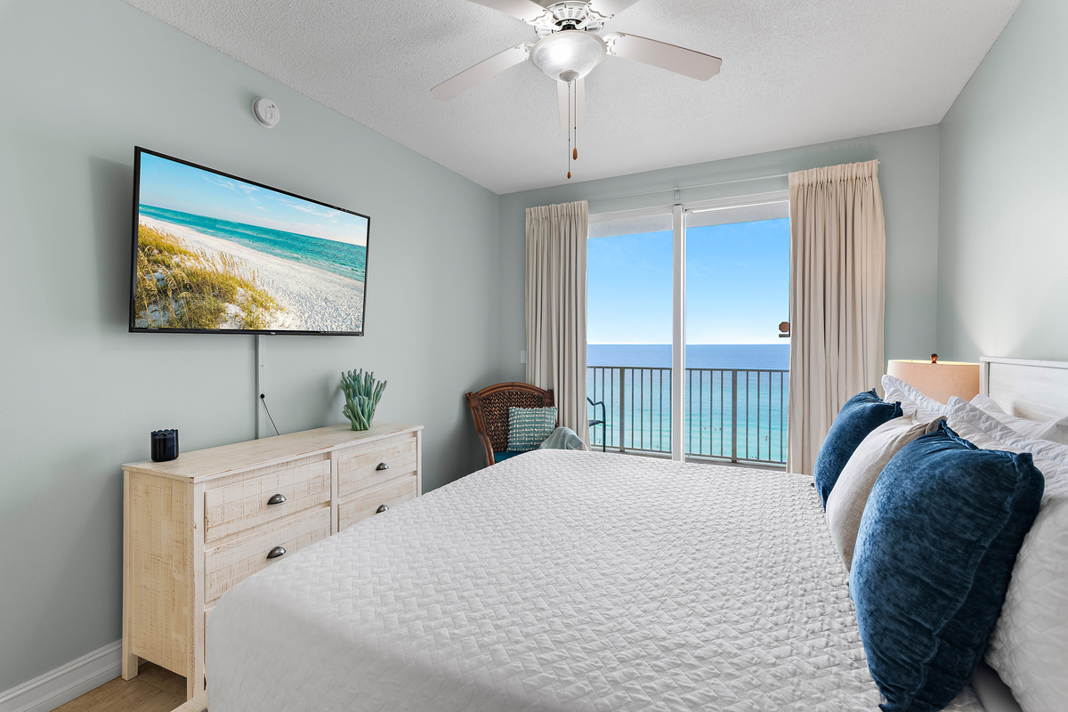 Spacious master bedroom features a King bed, Gulf views, balcony access, SMART TV w/ cable access, bathroom with dual vanity and shower/tub combo, and large closet.