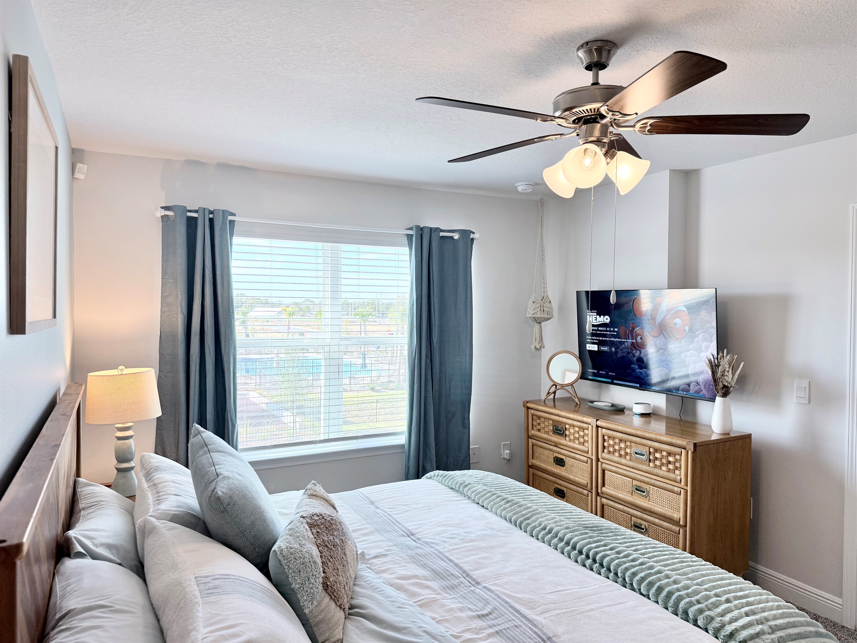 The airy primary bedroom with a great view of the recreation area