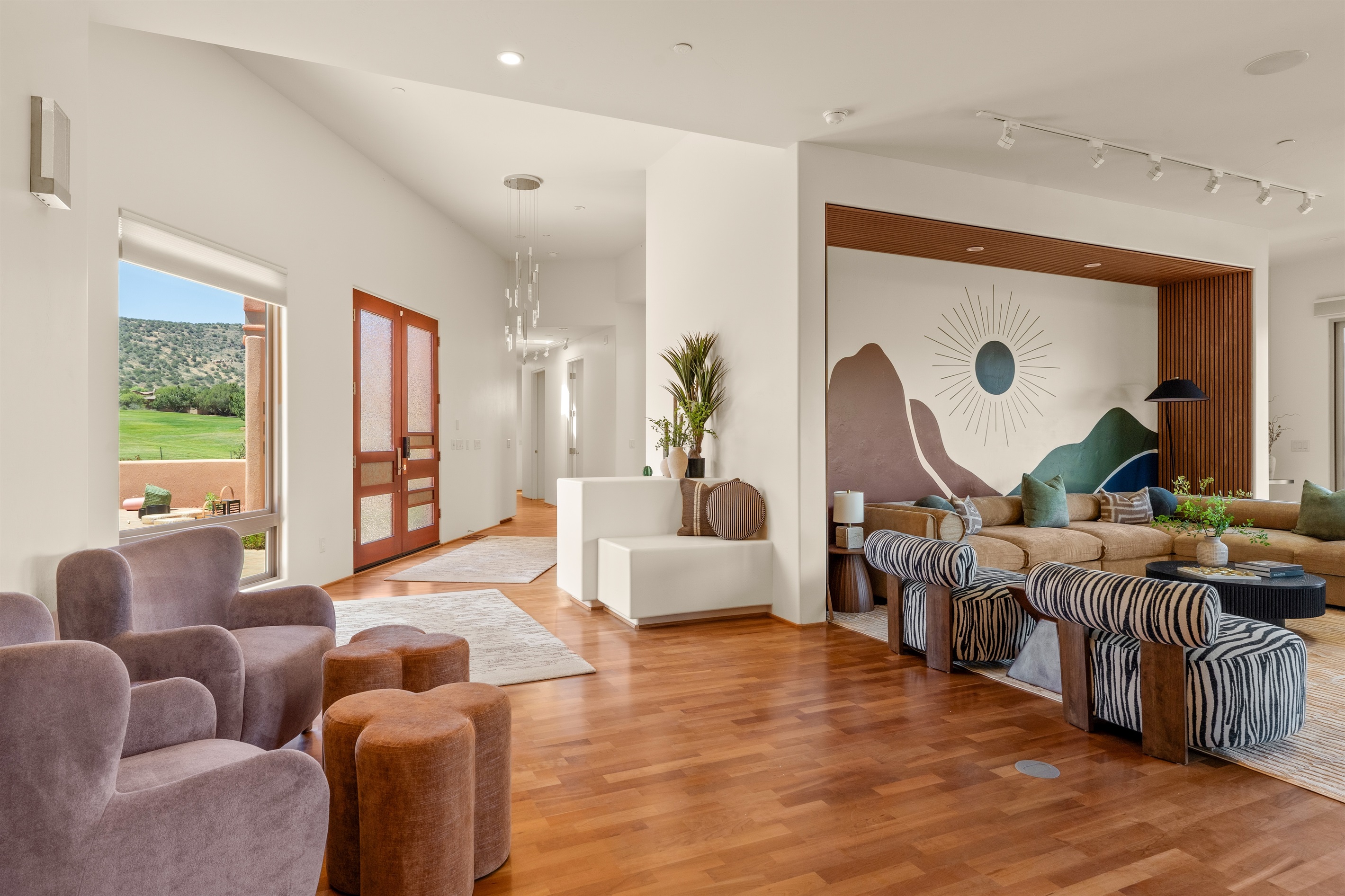 A grand arrival. The beautiful glass entryway flows seamlessly into the expansive living area, welcoming your group with striking architecture and abundant natural light.