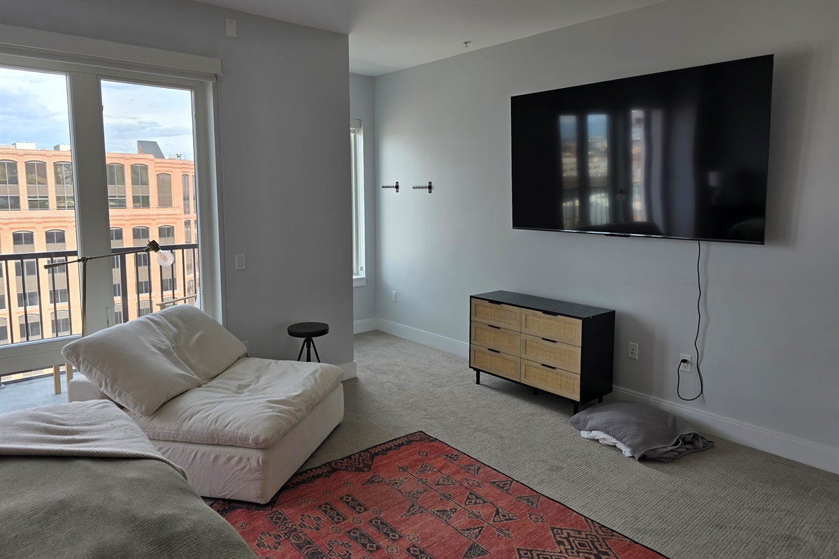 Main Bedroom has an 85" 4K Smart TV and Extra Seating Area
