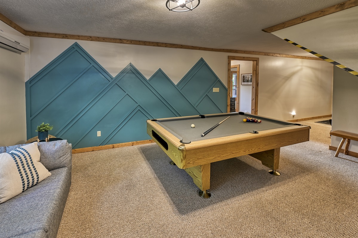 Head downstairs to the cozy game room couch. Enjoy watching your favorite game on the Roku smart TV while playing pool.