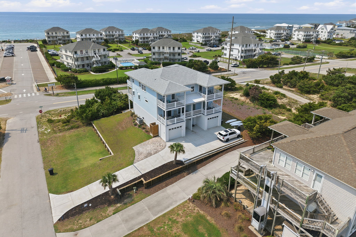 Aerial view of the property from the ocean side, capturing the home&rsquo;s balconies, outdoor spaces, and beautiful coastal surroundings