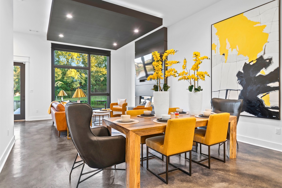 Enjoy meals and conversations in this thoughtfully designed dining space, surrounded by natural light and artistic decor.