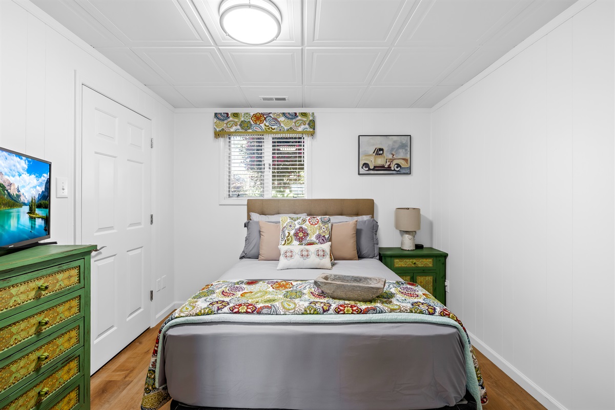 Guest bedroom with a full size bed. 