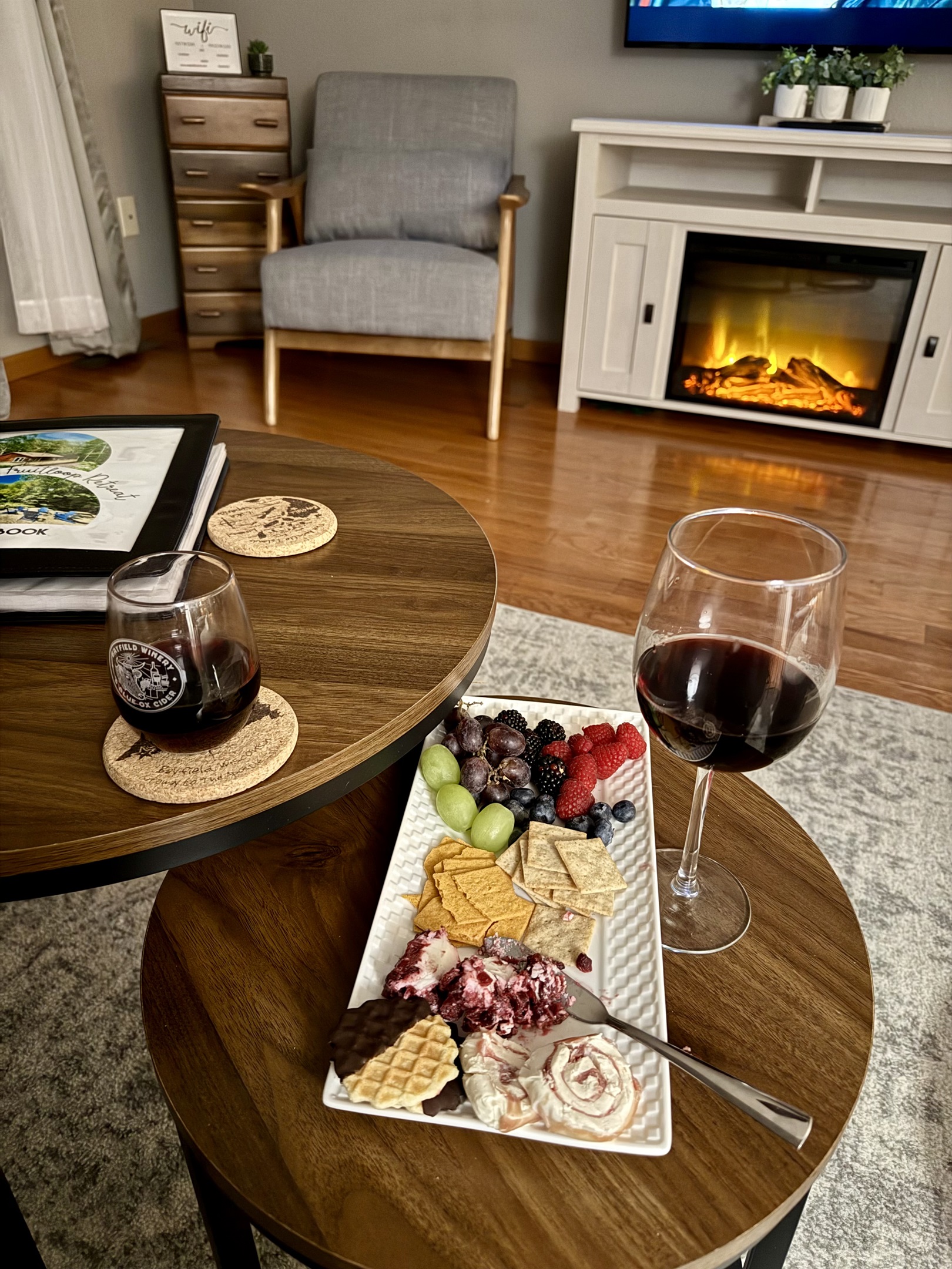 cozy up next to the electric fireplace In the upper level living room. Open concept kitchen living room with large windows overlooking the hill with woods. 