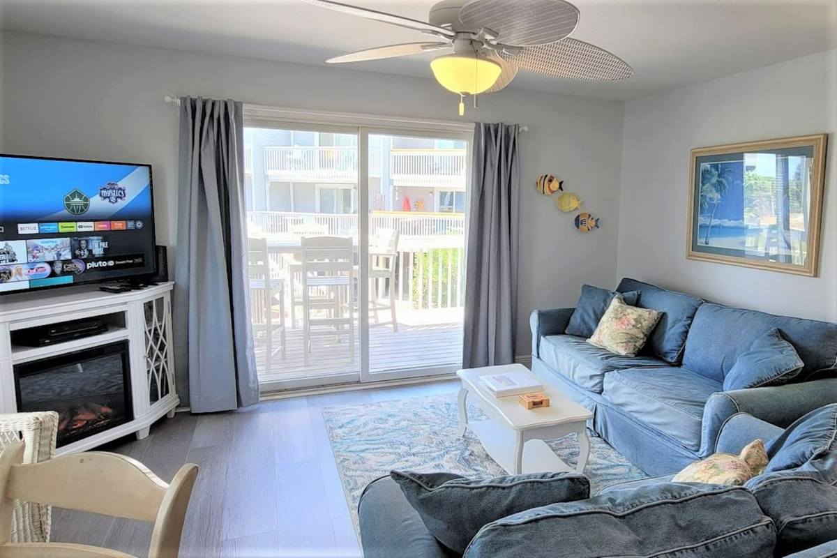 Sink into the living area after a day on the water &mdash; the corner fireplace cabinet and large Smart TV make staying in feel just as good.