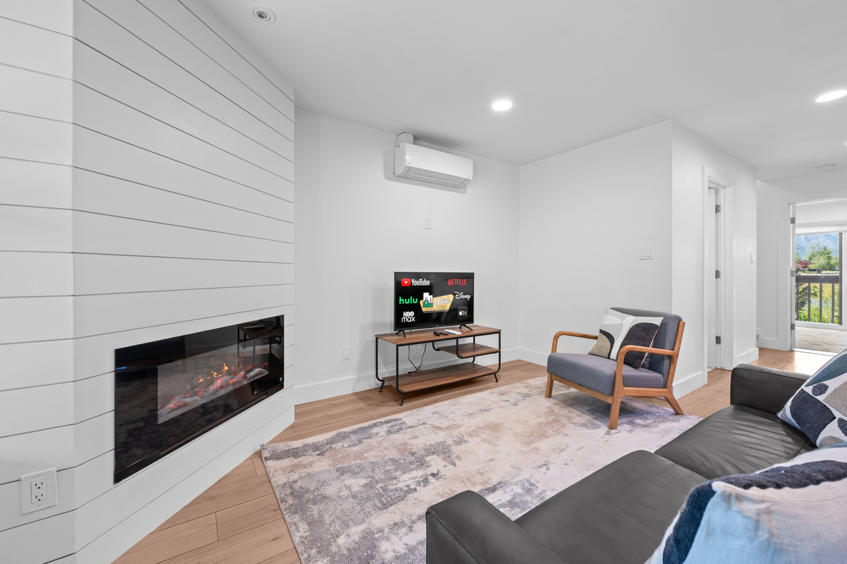 Bright and inviting living room featuring a cozy fireplace, Smart TV, and comfortable seating.