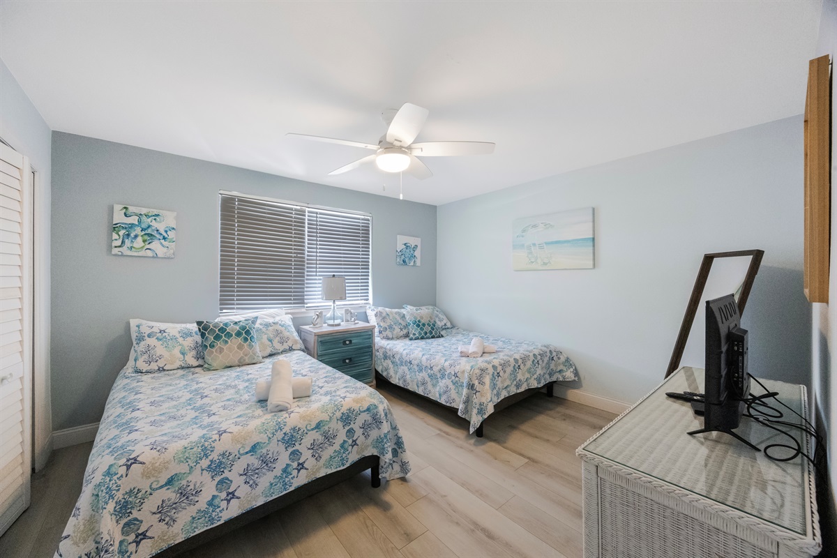 2nd bedroom, 2 full-sized beds, view of beach from the window
