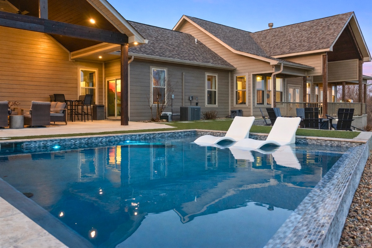 The backyard view of the home showcases the beautiful pool area and inviting outdoor spaces designed for relaxation and fun.
