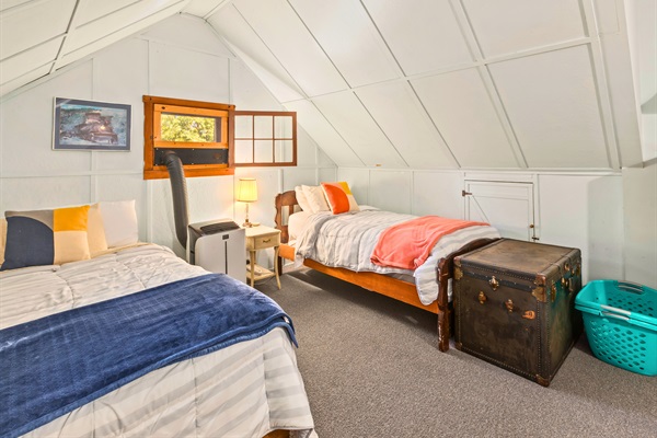 Twin beds in a bright, inviting upstairs space perfect for kids or friends to share.