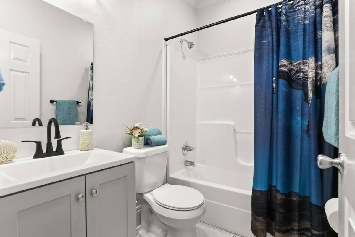 The en suite master bathroom features a tub/shower combo, shampoo, conditioner, & body wash, hair dryer, and plenty of towels.  