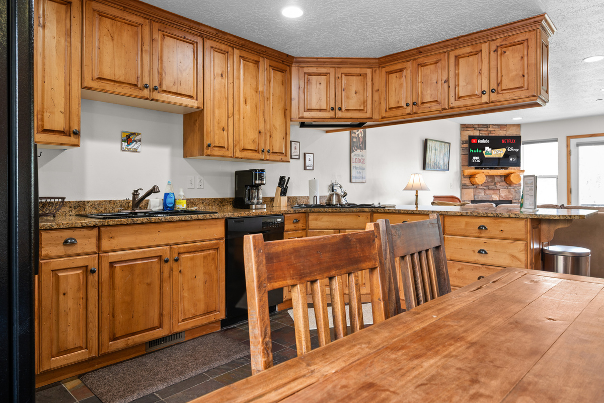 Gather around the dining table or kitchen island in this warm, open-concept space designed for shared meals and memorable moments.