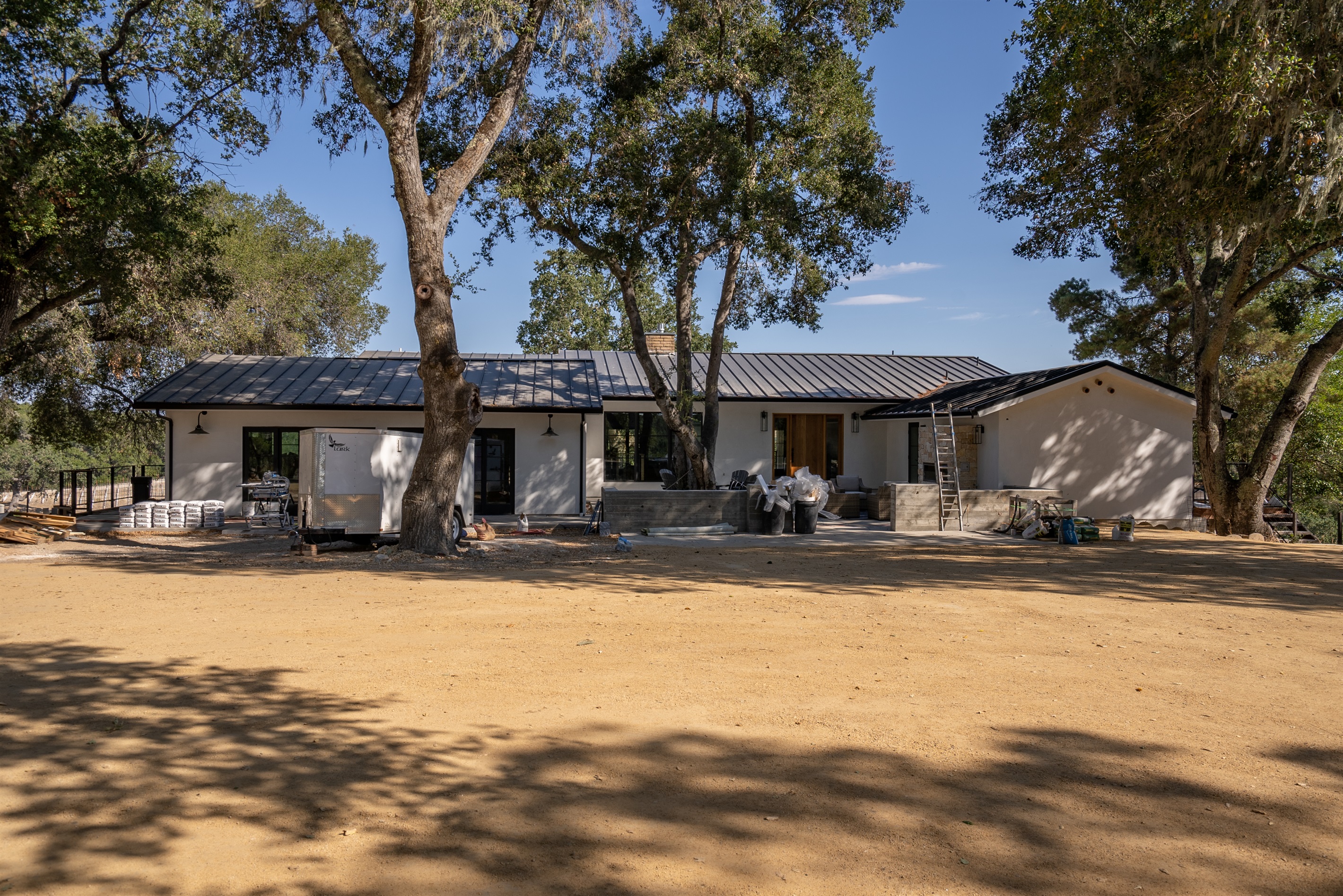 Modern retreat nestled among mature oaks.