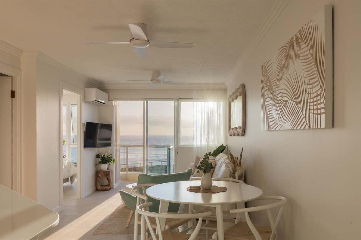Bright coastal living & dining space with ocean views from your table.