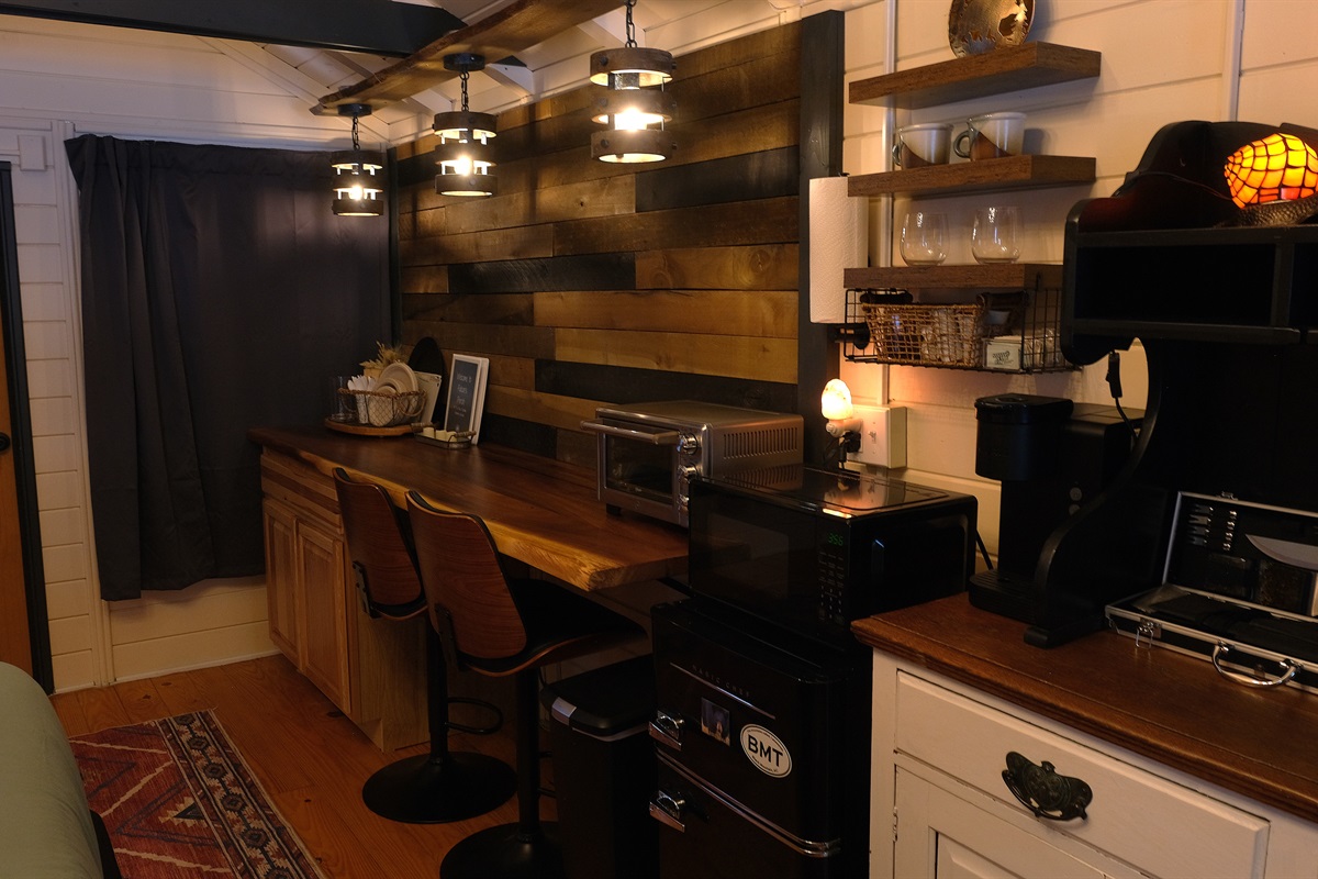 Kitchenette with minifridge, microwave, and Keurig.