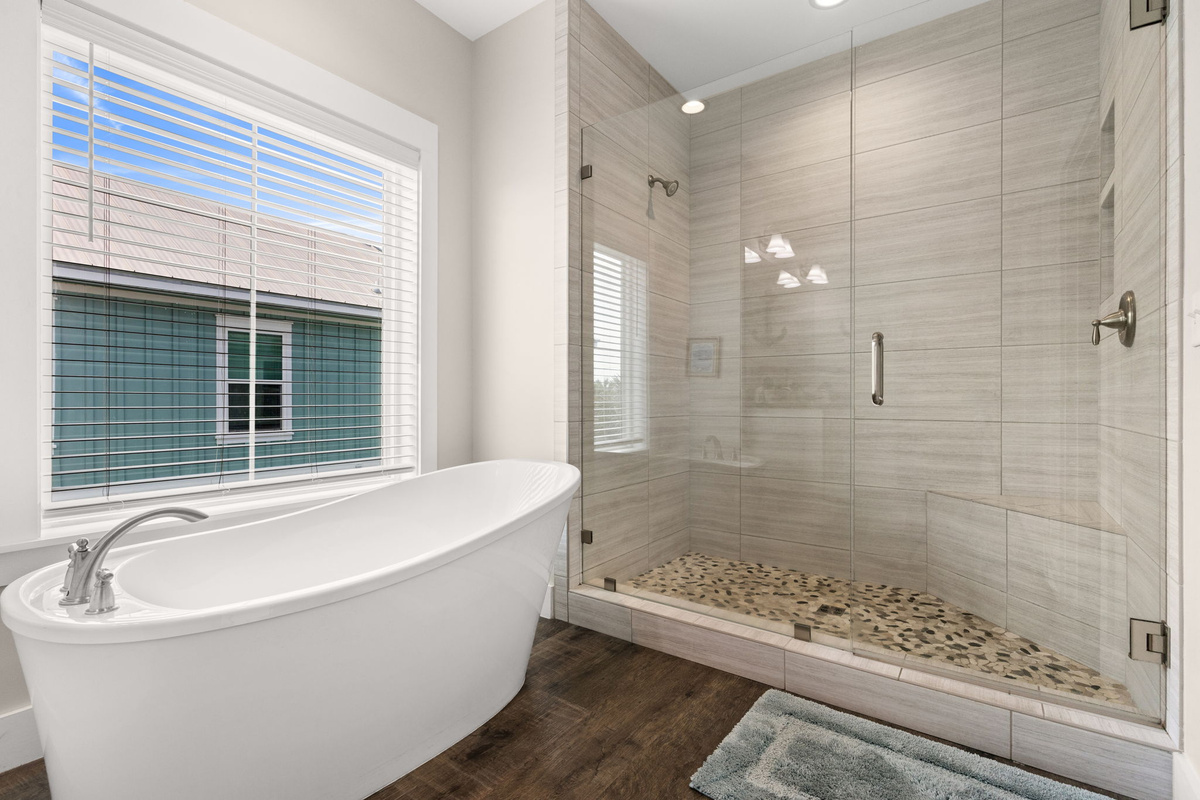 Second-floor master bathroom featuring large soaking tub, walk-in shower & double vanity