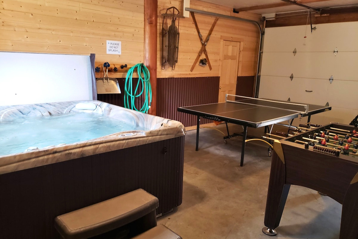 Heated garage game room for comfort and fun.  Includes hot tub, ping pong table.