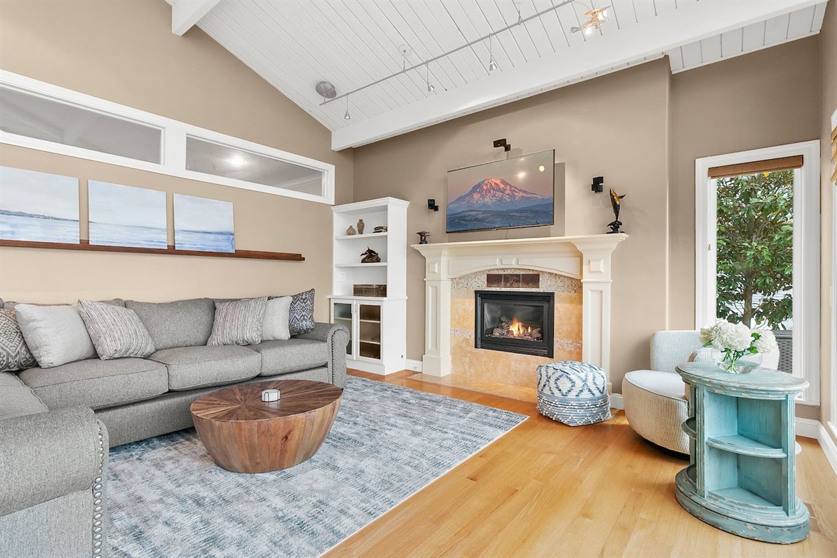 Enjoy the view from the living room on a rainy Seattle day, while reading a book with the fireplace warming you up.