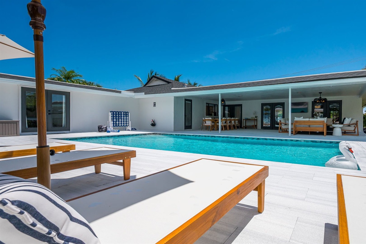 Spend your days lounging by the shimmering pool, dining al fresco under the covered patio, and unwinding in stylish outdoor living spaces—all set against a serene lakefront backdrop with private dock access