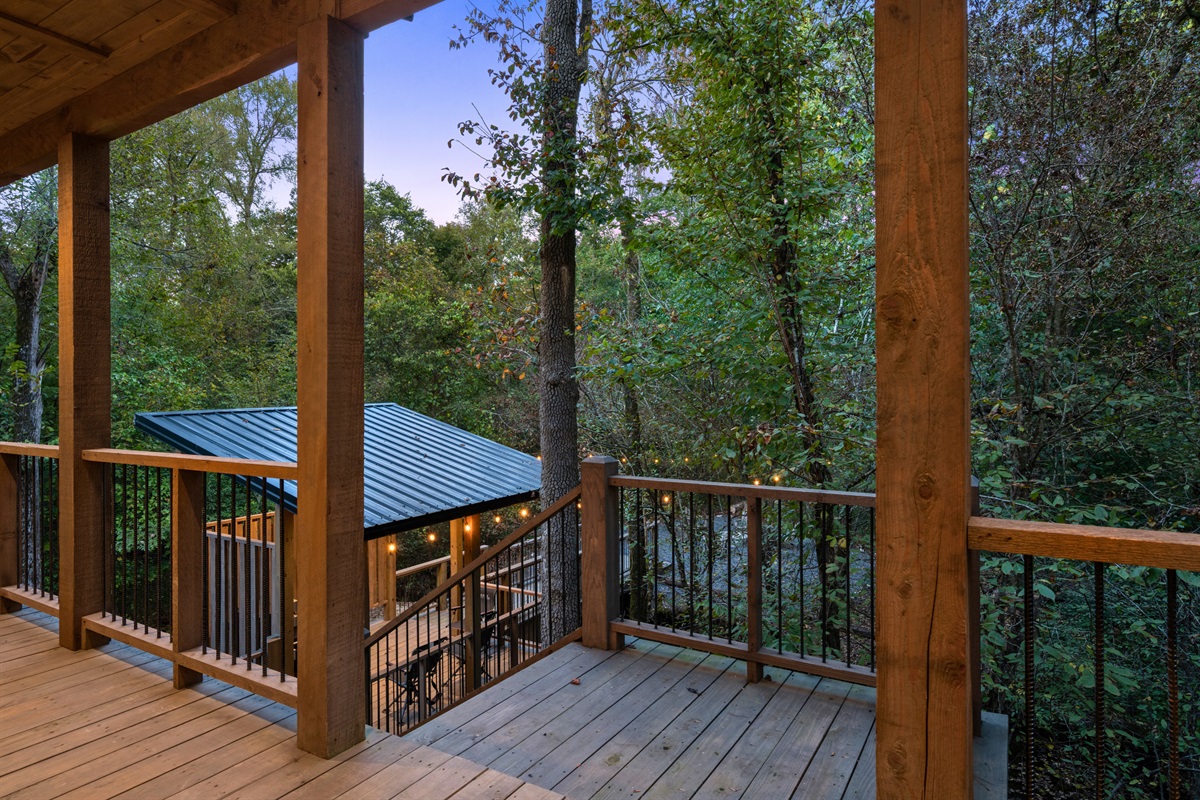 Another peaceful corner of the porch looks out toward the trees, creating a calm place to sit and take in the natural surroundings.