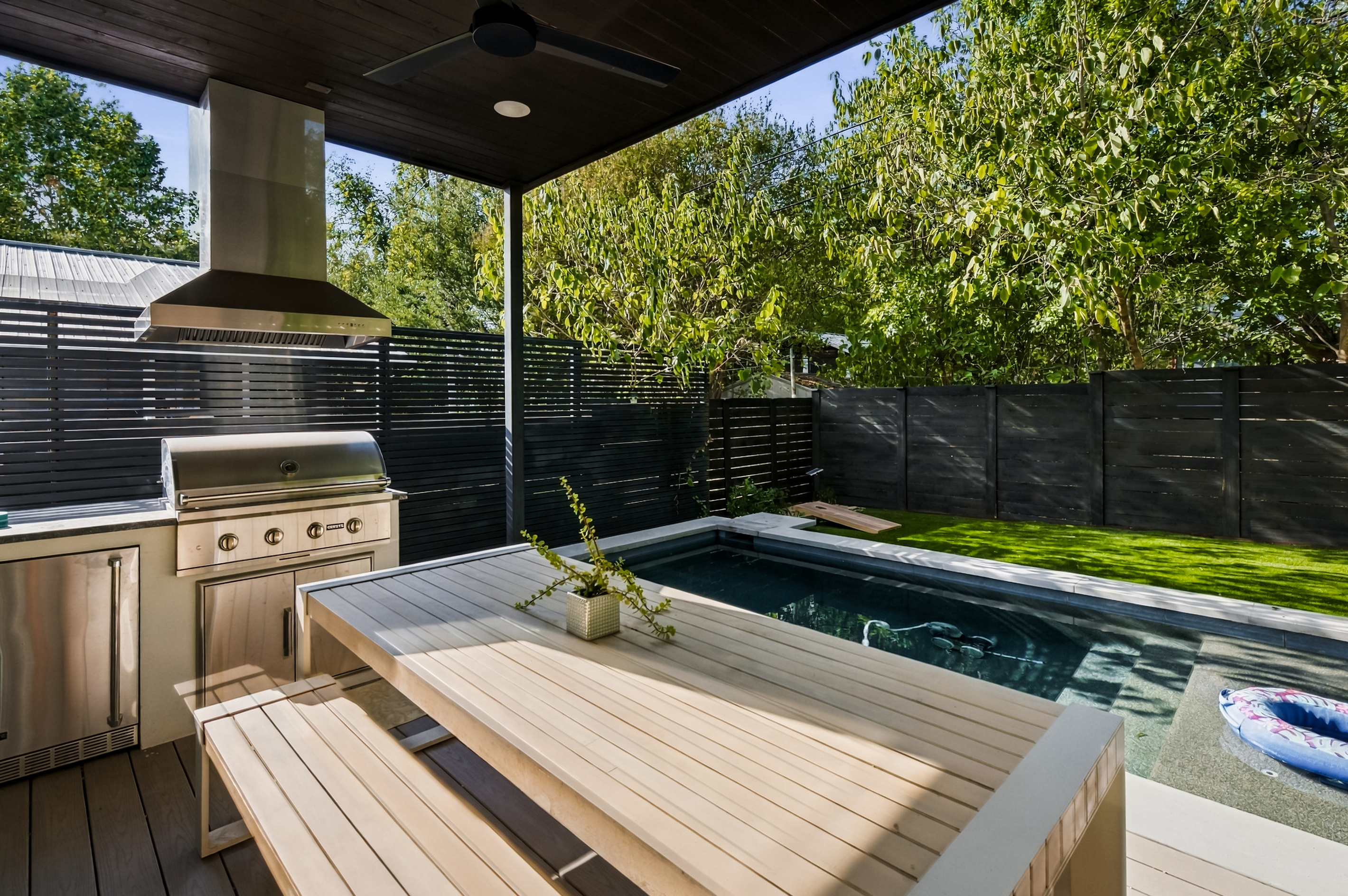 Grill, dine, and swim — the outdoor dining table seats up to 8, just steps from the pool.