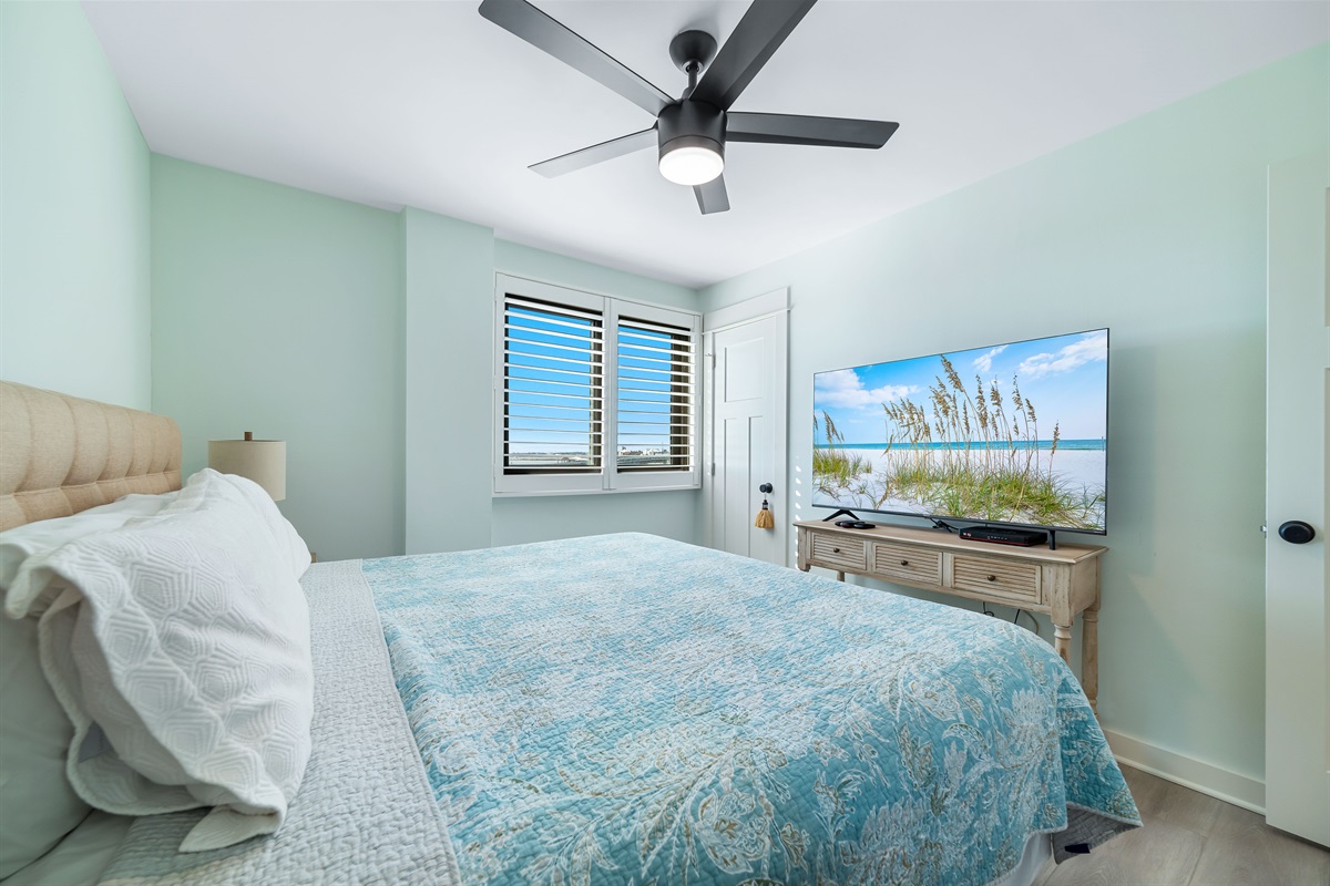 Light and airy bedroom with a classic coastal palette and elegant furnishings, creating a calming atmosphere.