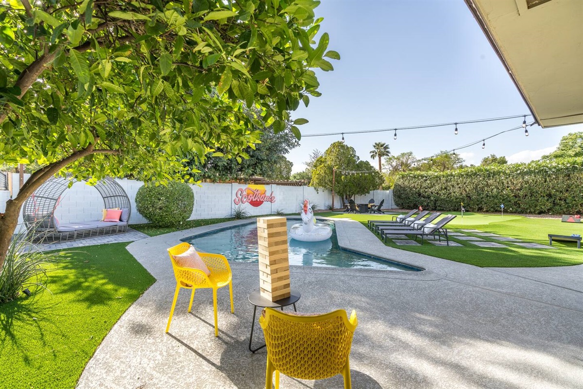 Large pool with Baja step; yard games; sun loungers; putting green; gas fire pit - this exquisite back yard has it all!Pool can be heated for add'l fee.