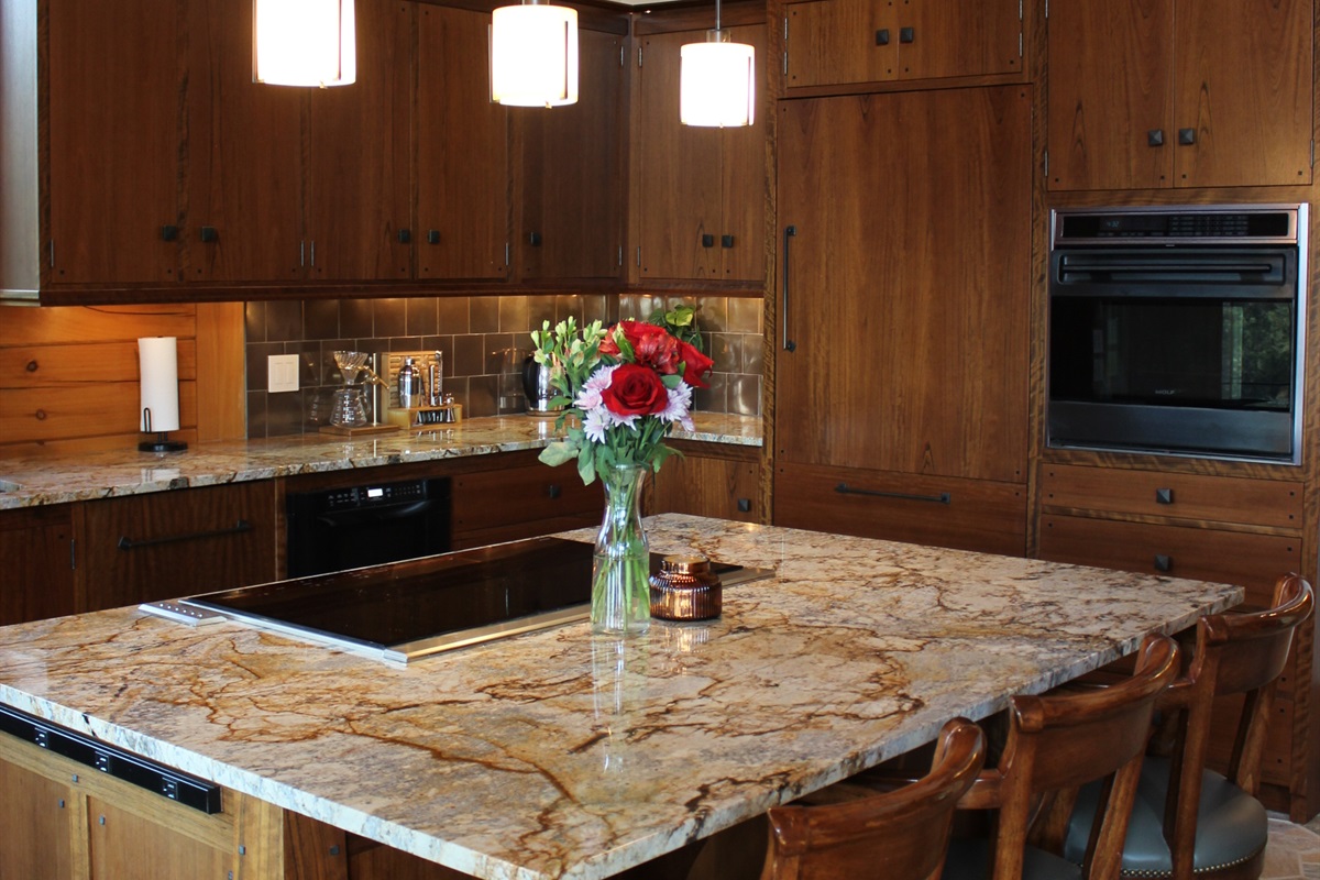 Large kitchen island with stove and 3 bar stools