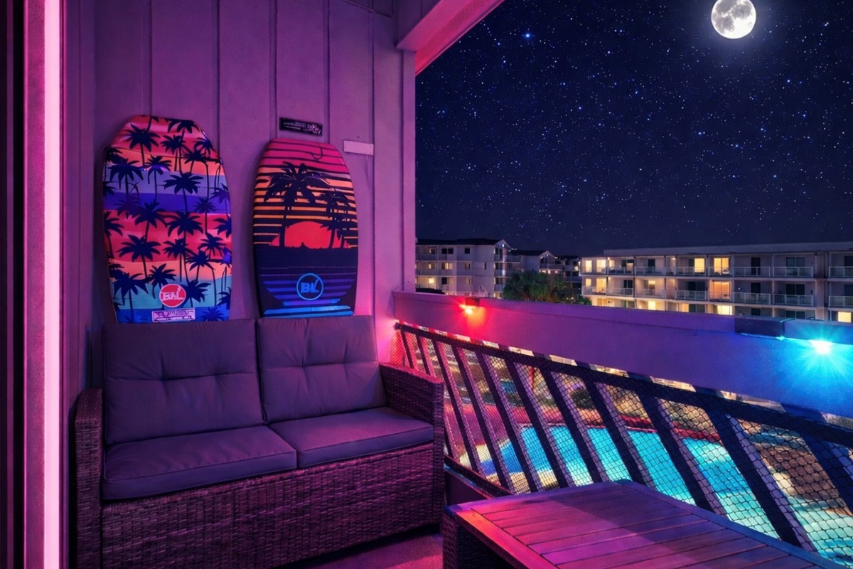 Glow-up escape ✨ A private LED-lit balcony wrapped in pink and blue ambiance, overlooking the shimmering pool below. Seating for 4 for sunset unwinding, midnight conversations — this is your after-beach exhale. Cozy lounge loveseat w 2 chairs.