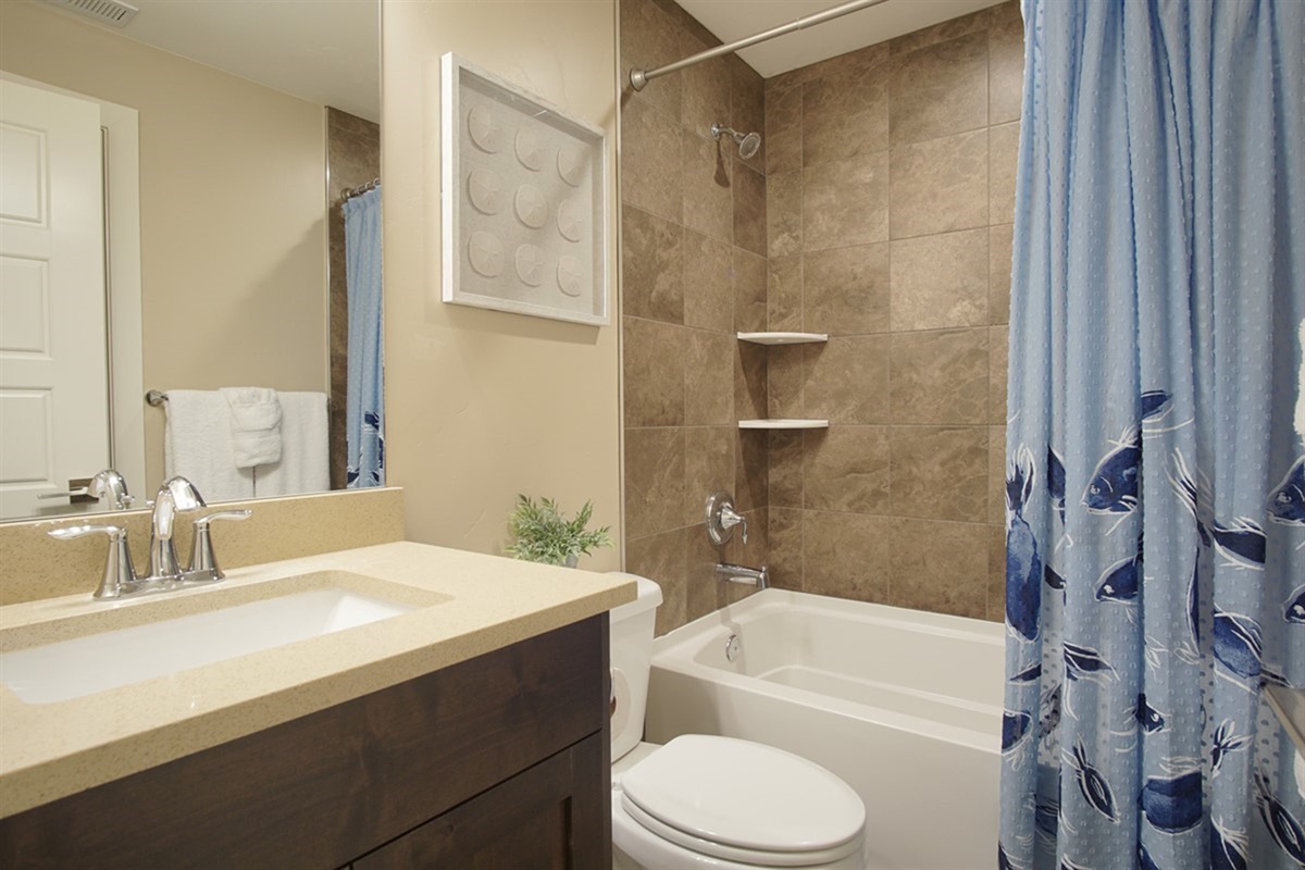 Stylish bathroom with modern finishes and full tub/shower combination.