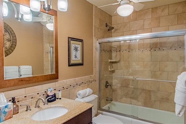 Guests bathroom with shower and bathtub combination.