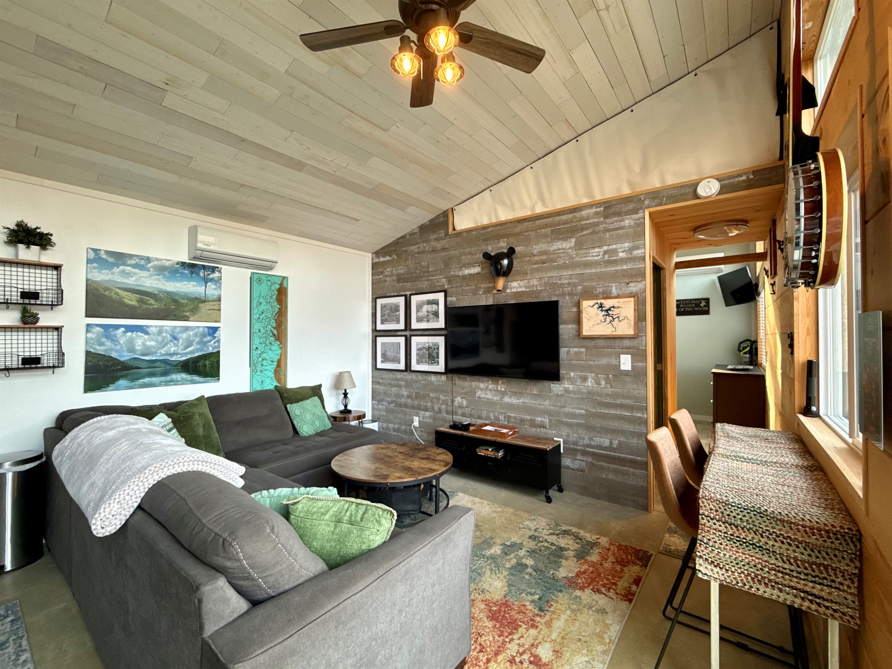 Natural light, thoughtful artwork, and sweeping views make the living room feel warm, simple, and inviting.