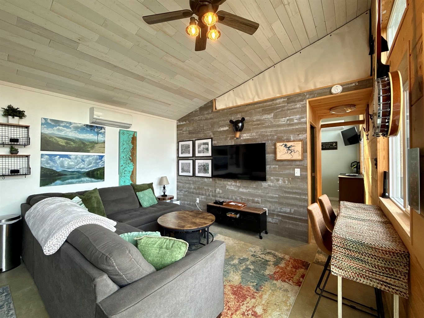 Natural light, thoughtful artwork, and sweeping views make the living room feel warm, simple, and inviting.