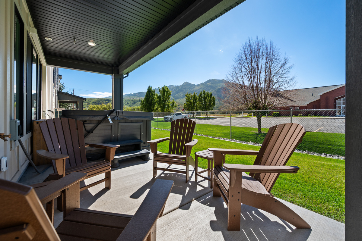 A covered outdoor sitting area offers a relaxed place to enjoy fresh air and time together outside.