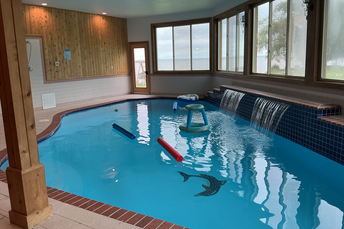 Indoor pool with lake view and waterfalls