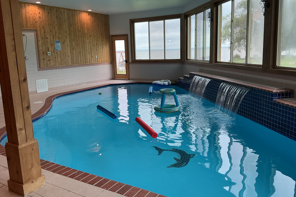 Indoor pool with lake view and waterfalls