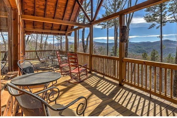 Covered deck with café seating and sweeping Blue Ridge Mountain views. Perfect for morning coffee or sunset wine.