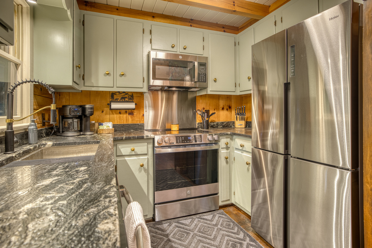 Kitchen with a stainless fridge and range.