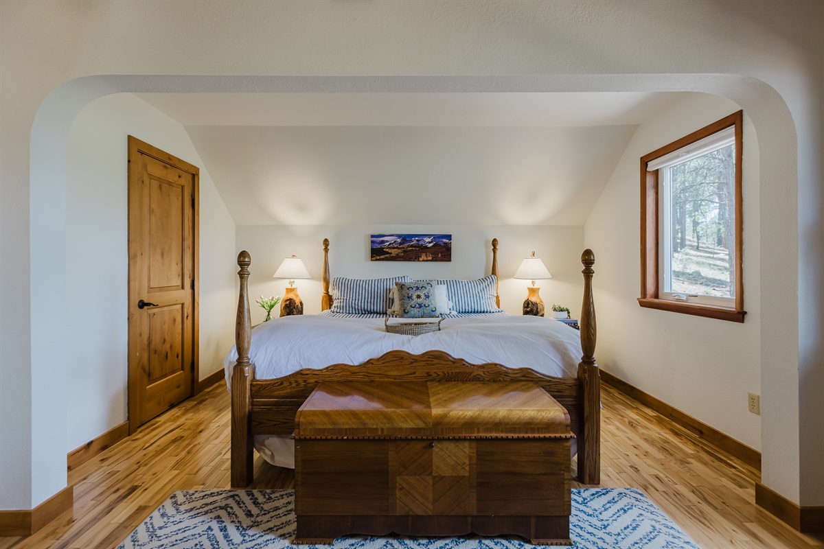 Master bedroom king size bed with plenty of room and an attached bathroom.