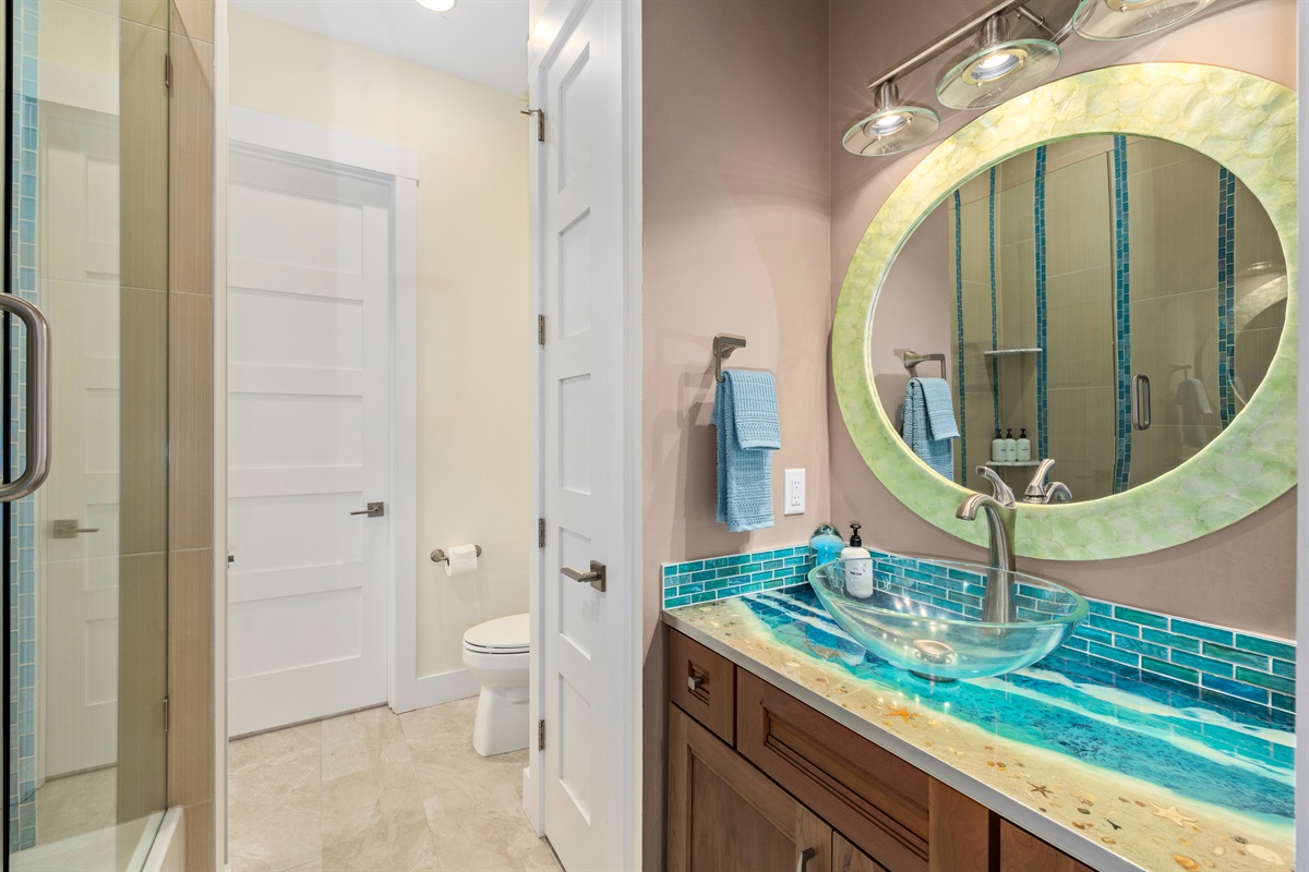 Full bathroom off bunk room with bold coastal design and modern finishes