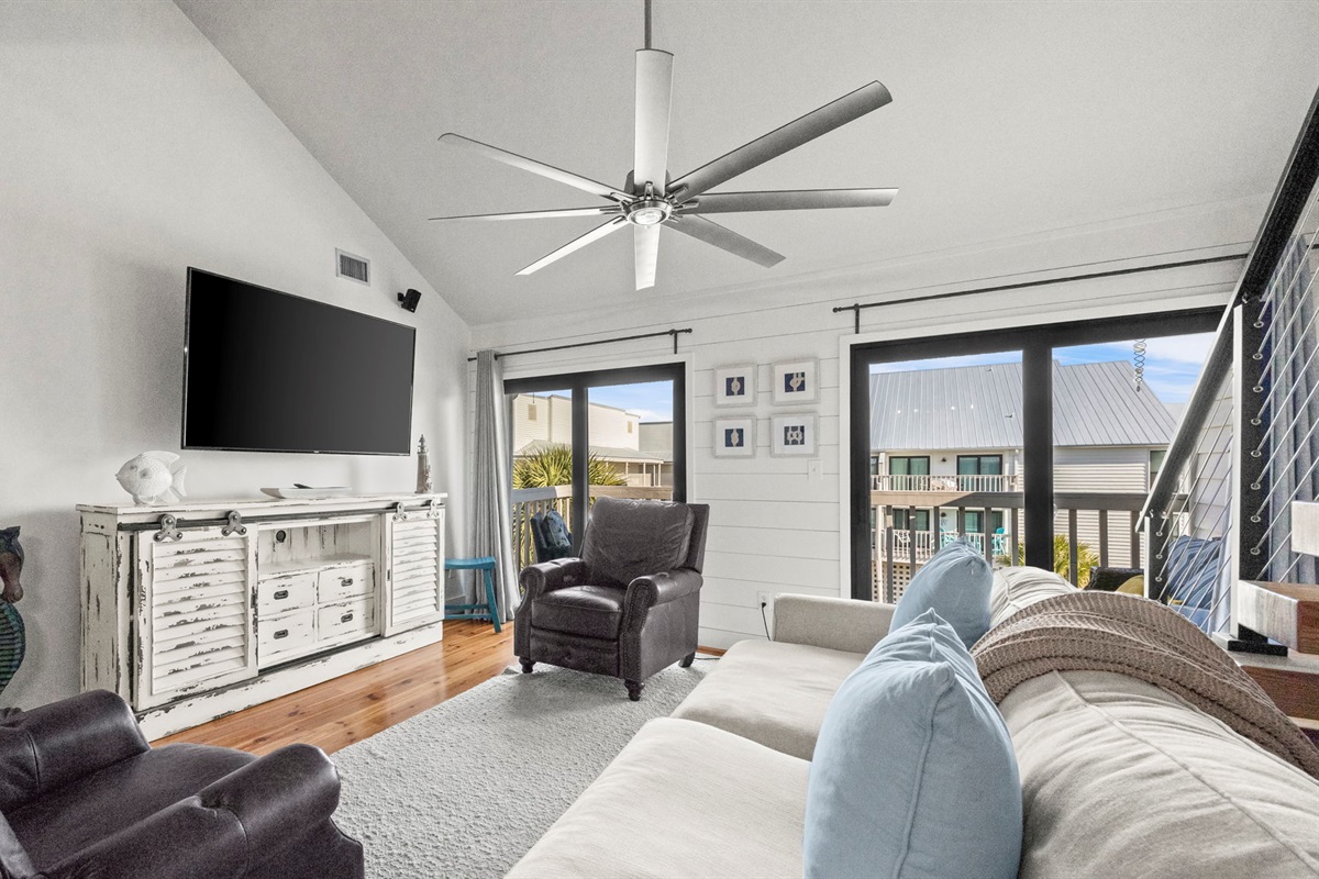 Enjoy the updated living room in our Cotton Bayou condo, featuring stylish coastal decor, a smart TV, and comfortable seating. The perfect space to unwind and relax after a day at the pool or on the wate