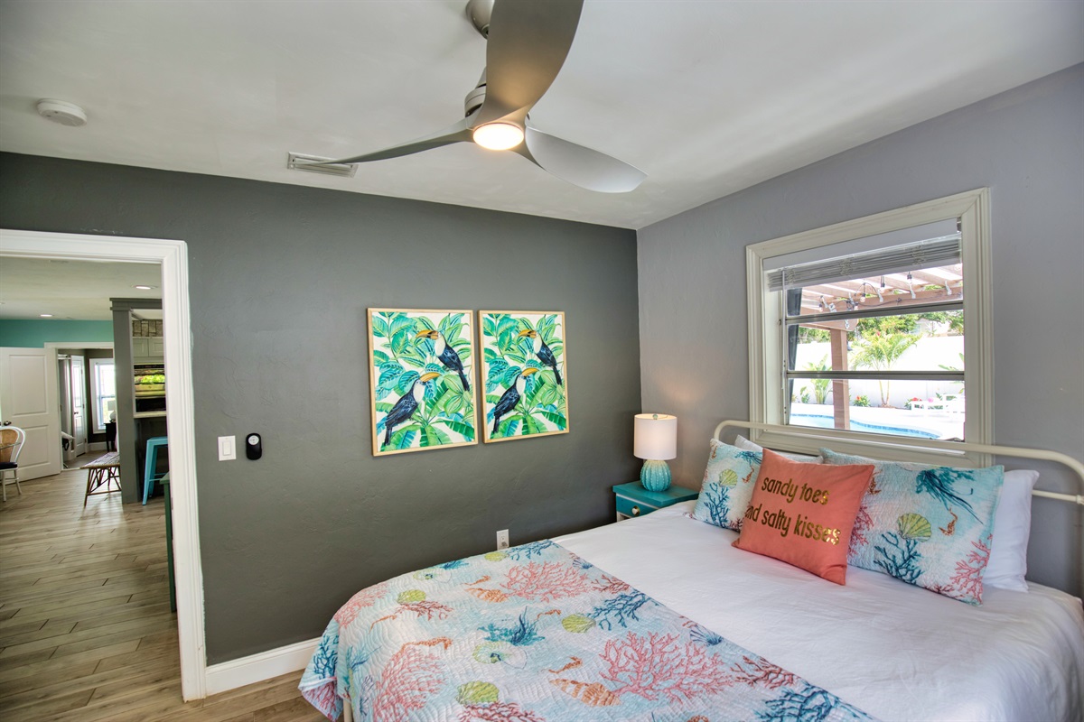 The SECOND BEDROOM has a cozy queen bed featuring a ceiling fan with plenty of storage in the roomy closet.