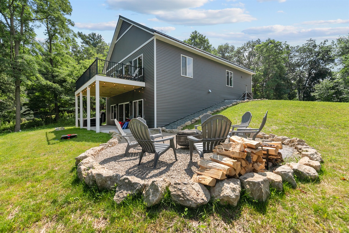 As the sun dips below the trees, you gather around the fire pit with a blanket and a drink in hand.