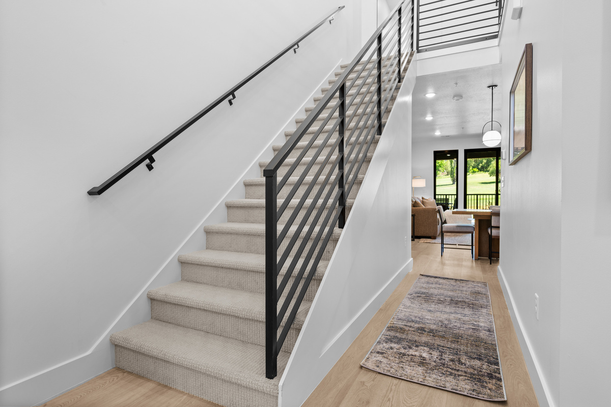 Stairway leading to the spacious upper-level family retreat.