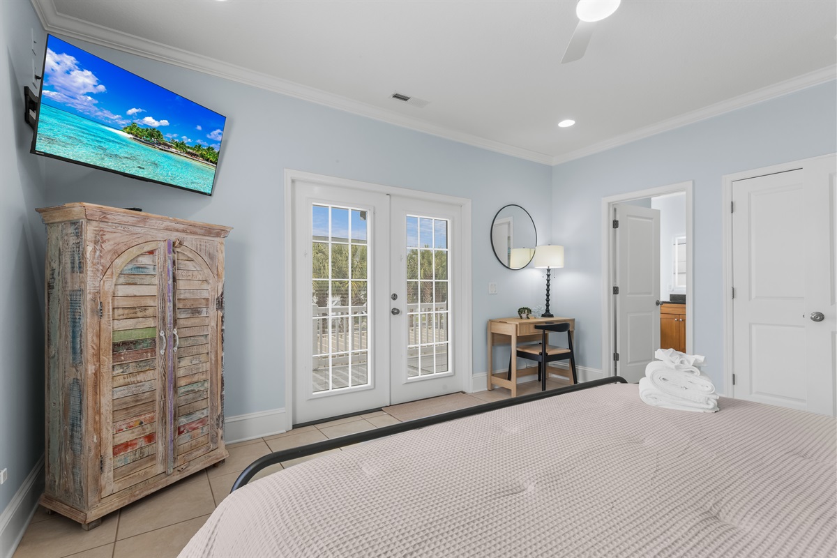 Primary suite main level with direct access to a private balcony. If you must work while on vaca relax at the stylish workstation